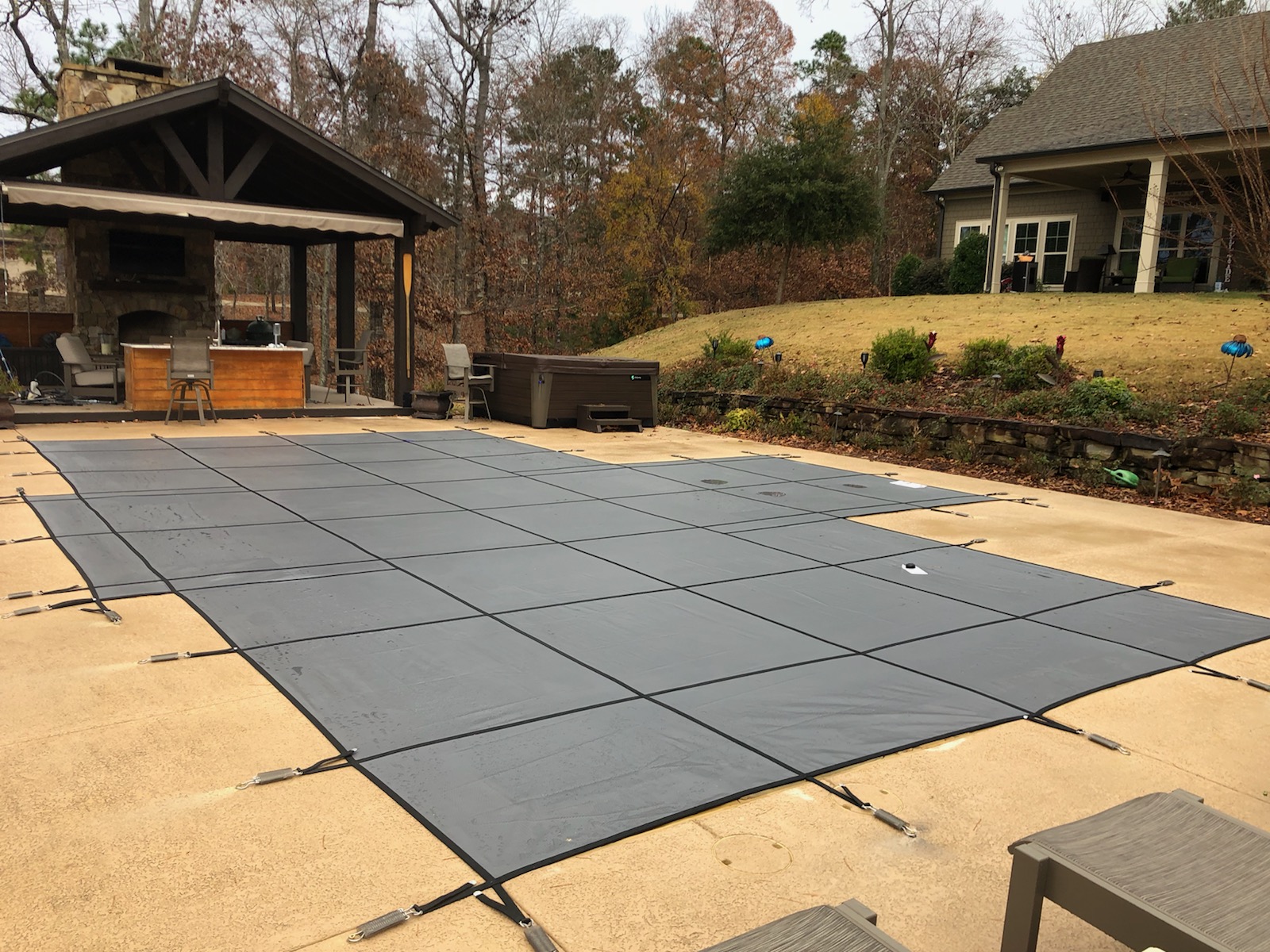 Pool safety cover installation overview showing full coverage and anchor points