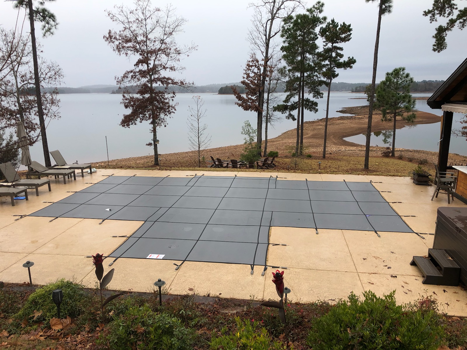 Blue mesh safety cover installed on rectangular in-ground pool &mdash; Bender residence