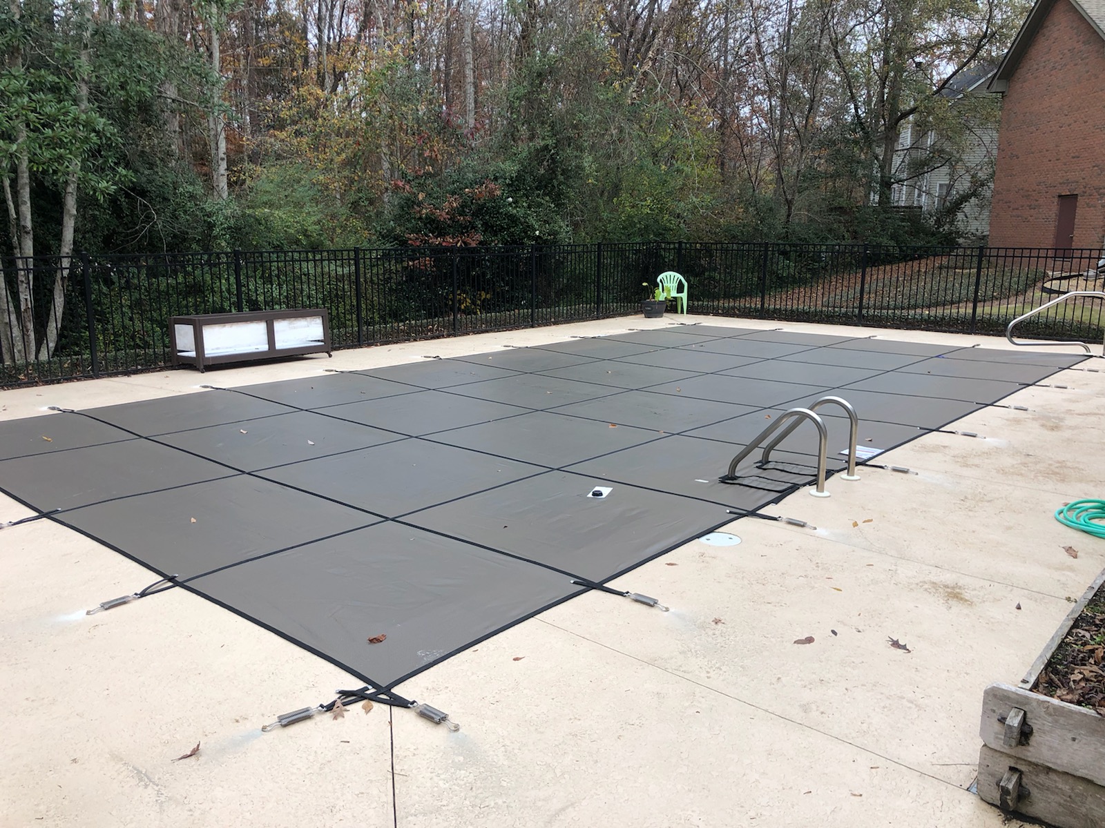 Anchored pool safety cover detail view showing hardware installation
